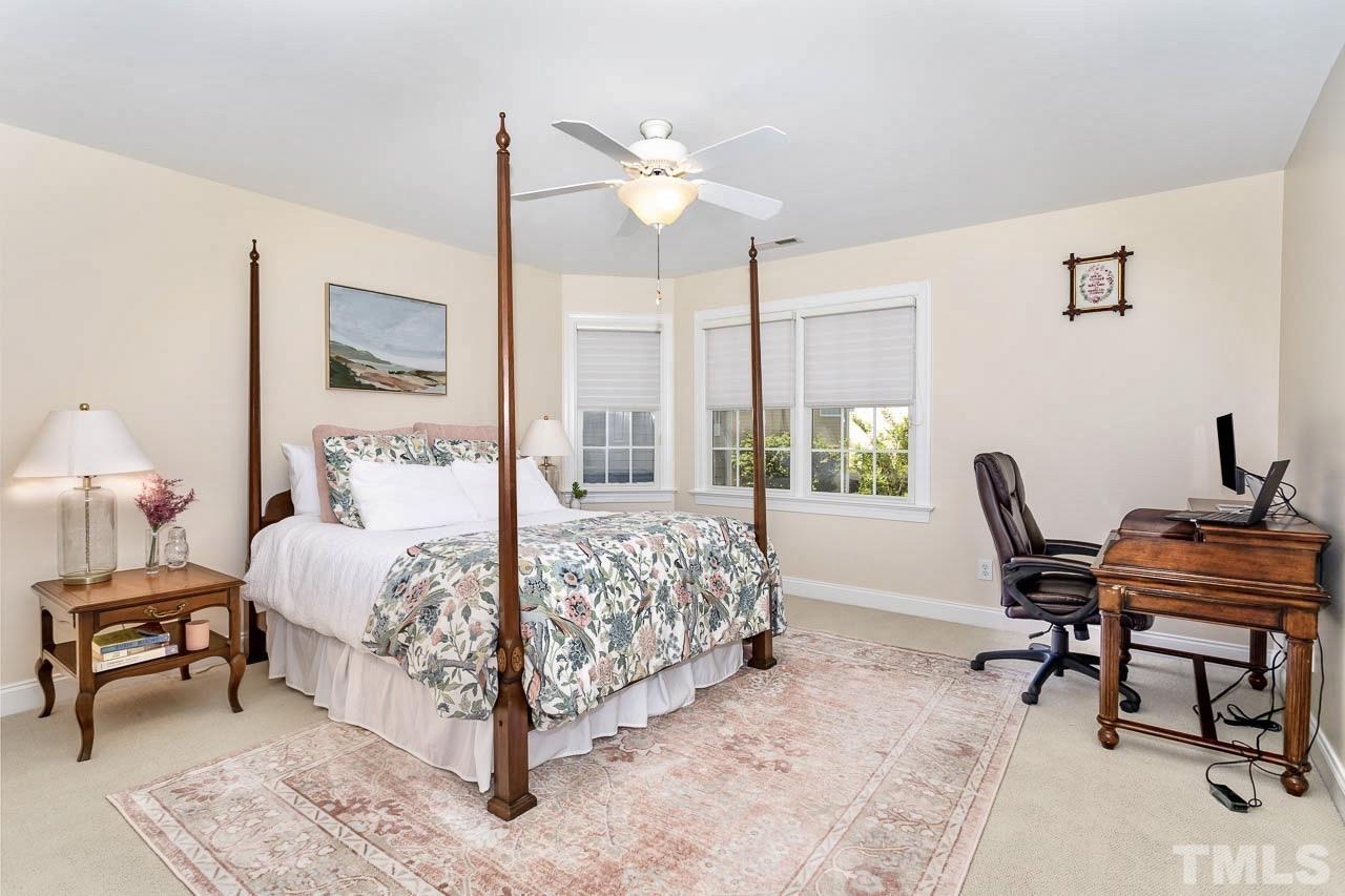 8333 Wheatstone Lane Raleigh, NC 27613 - Photo 22 of 34 a bedroom with a bed a chair and a large window