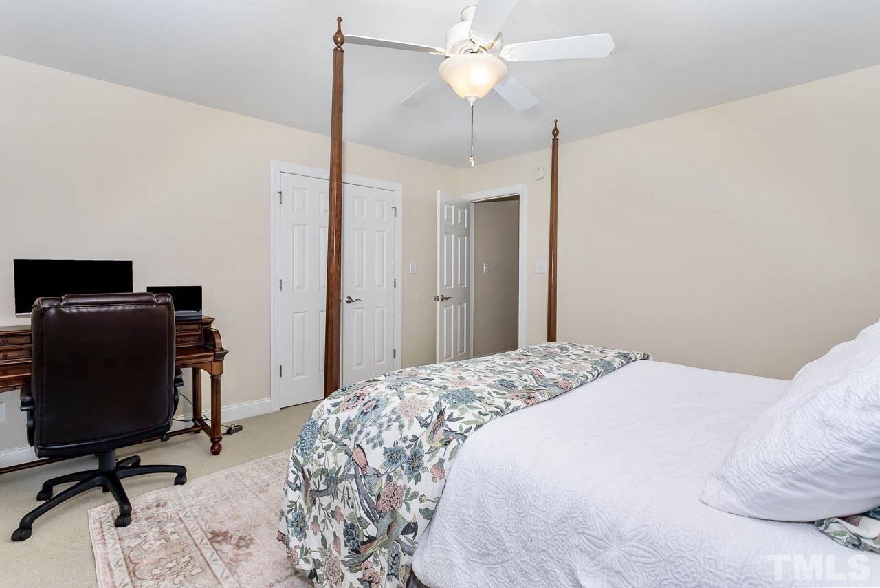 8333 Wheatstone Lane Raleigh, NC 27613 - Photo 23 of 34 a bedroom with a bed and a desk