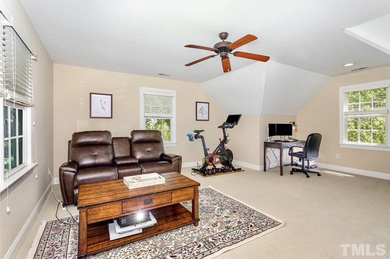 8333 Wheatstone Lane Raleigh, NC 27613 - Photo 25 of 34 a living room with furniture a air conditioner and a window