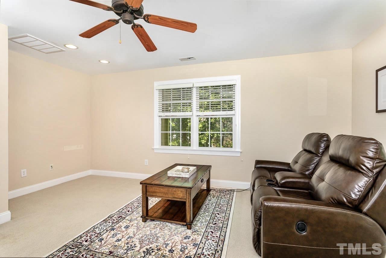 8333 Wheatstone Lane Raleigh, NC 27613 - Photo 26 of 34 a living room with furniture and a window