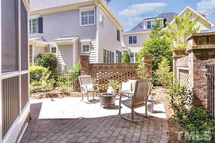8333 Wheatstone Lane Raleigh, NC 27613 - Photo 32 of 34 a view of a patio with a table and chairs and potted plants