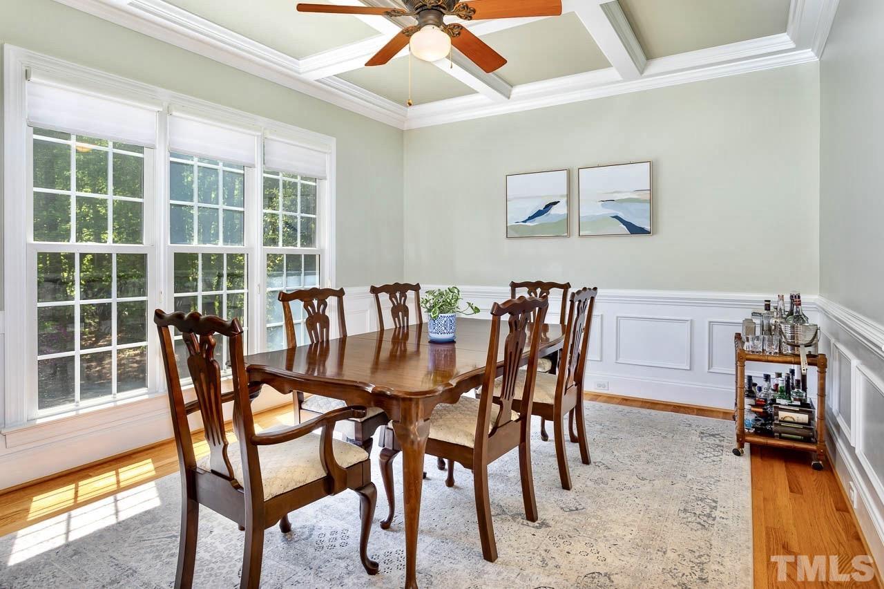 8333 Wheatstone Lane Raleigh, NC 27613 - Photo 5 of 34 a dining room with furniture a rug and a large window
