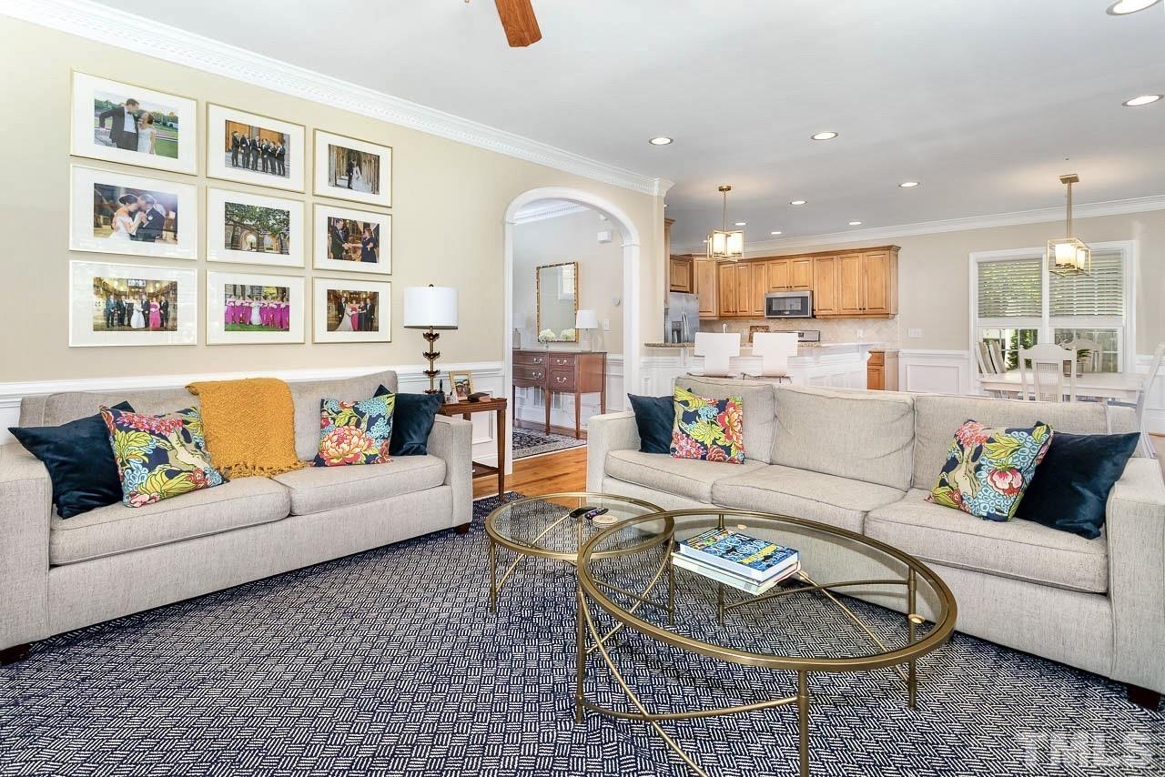 8333 Wheatstone Lane Raleigh, NC 27613 - Photo 7 of 34 a living room with furniture kitchen and a rug