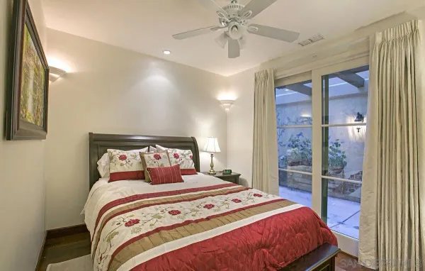 a bedroom with a large bed and a chandelier