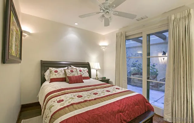 a bedroom with a large bed and a chandelier