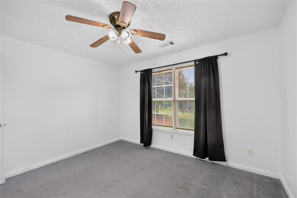 602 Pendergrass Road Winder, GA 30680 - Photo 29 of 44 an empty room with windows and fan