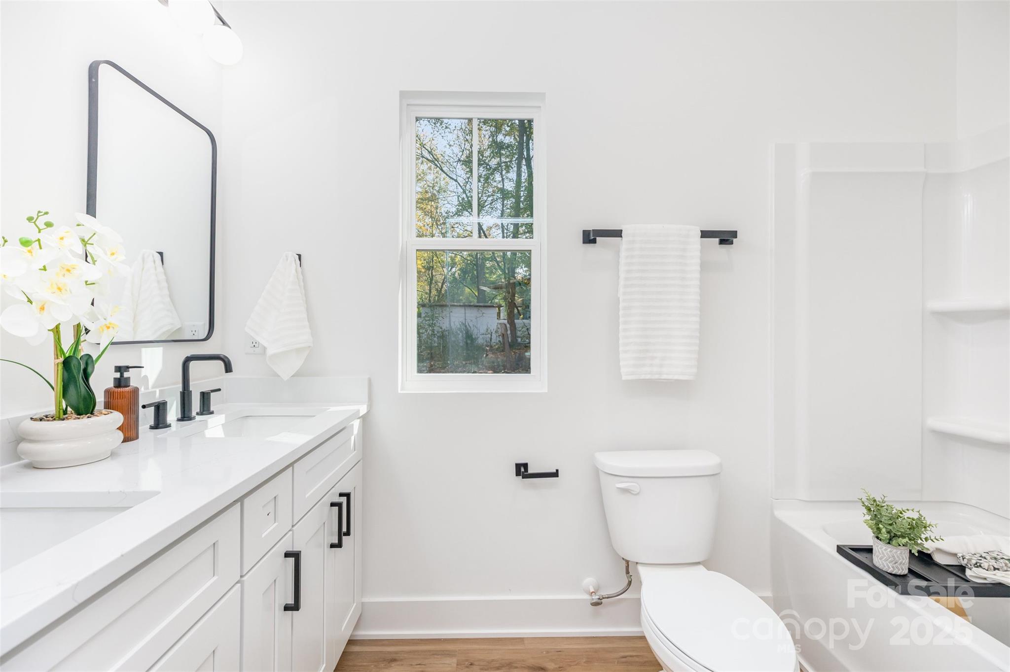 2802 Walkup Avenue Monroe, NC 28110 - Photo 11 of 16 a bathroom with a sink a toilet and mirror