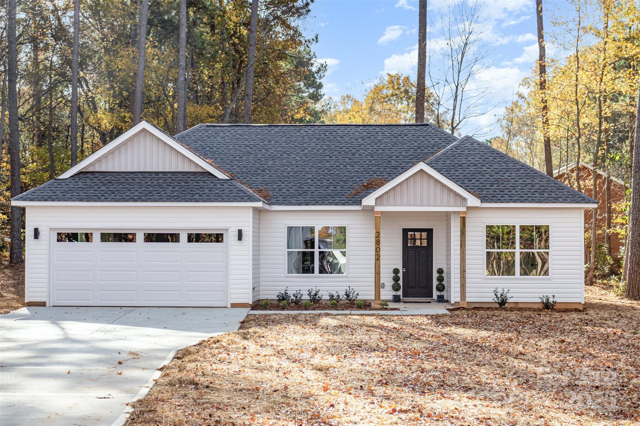 2802 Walkup Avenue Monroe, NC 28110 - Photo 14 of 16 a front view of a house with a yard and garage