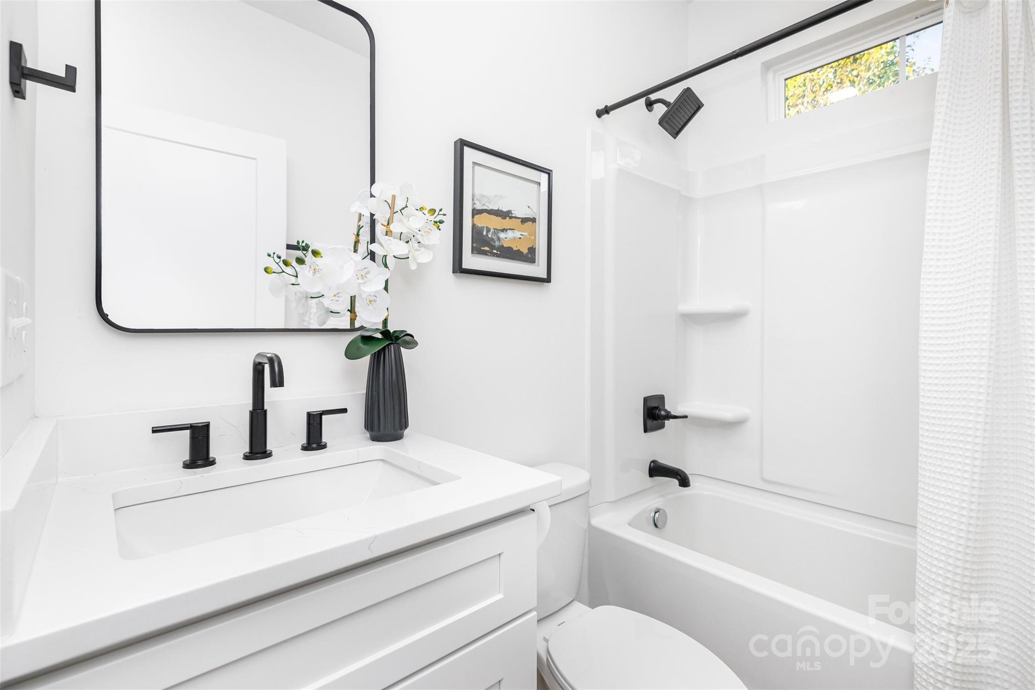 2802 Walkup Avenue Monroe, NC 28110 - Photo 8 of 16 a bathroom with a sink a toilet and a bathtub