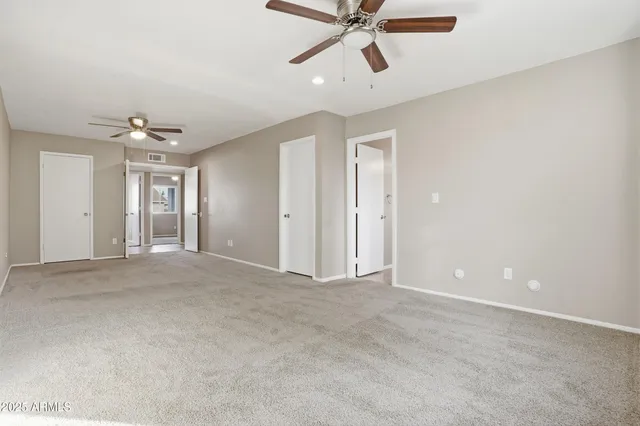 a view of a livingroom with a ceiling fan and window