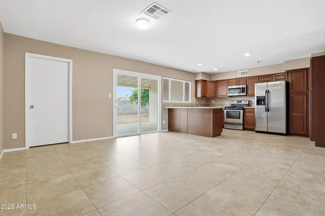 a view of kitchen with refrigerator and microwave