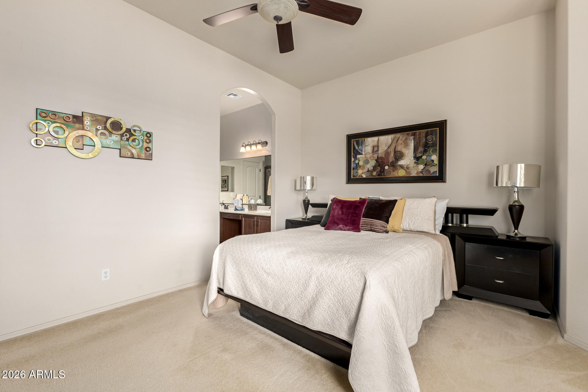 6202 East McKellips Road, Unit 277 Mesa, AZ 85215 - Photo 17 of 55 a bedroom with bed and paintings on the wall