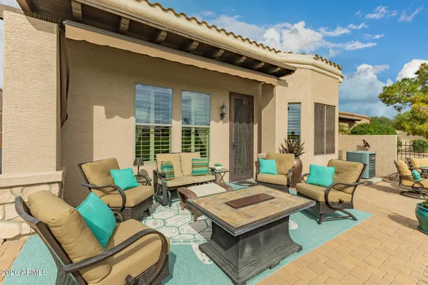 a roof deck with couches and city view
