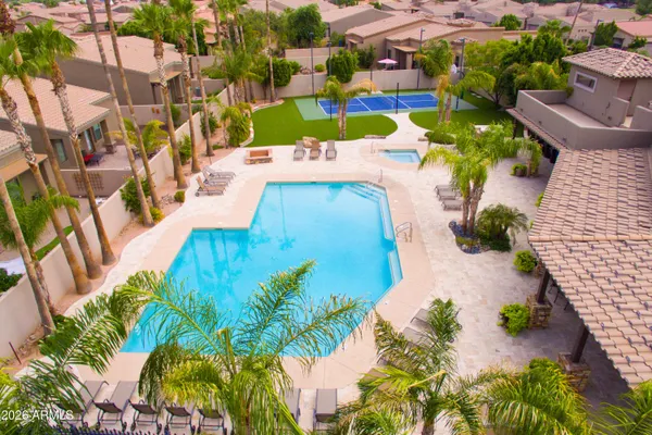 swimming pool view with a seating space