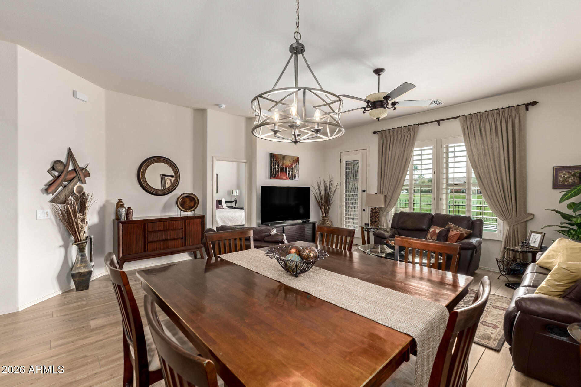 6202 East McKellips Road, Unit 277 Mesa, AZ 85215 - Photo 10 of 55 a view of a dining room with furniture window and wooden floor