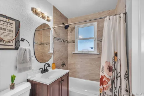 a bathroom with a sink a window and a mirror