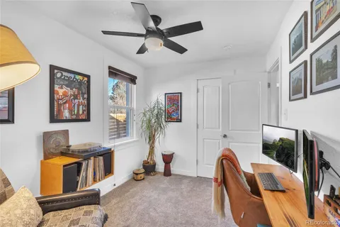 a living room with furniture and flowers