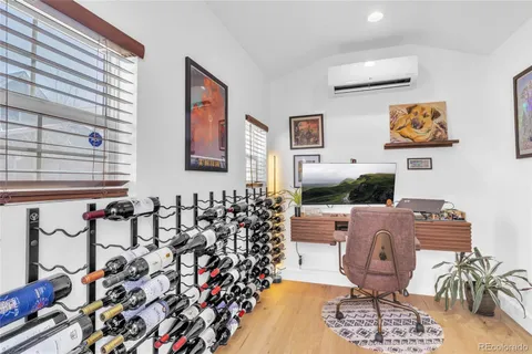 a view of a house with sitting area and large trees