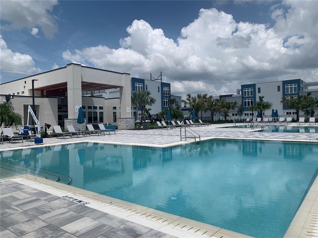 7770 Sandy Ridge Drive, Unit 210 Reunion, FL 34747 - Photo 41 of 42 a view of a swimming pool with outdoor seating
