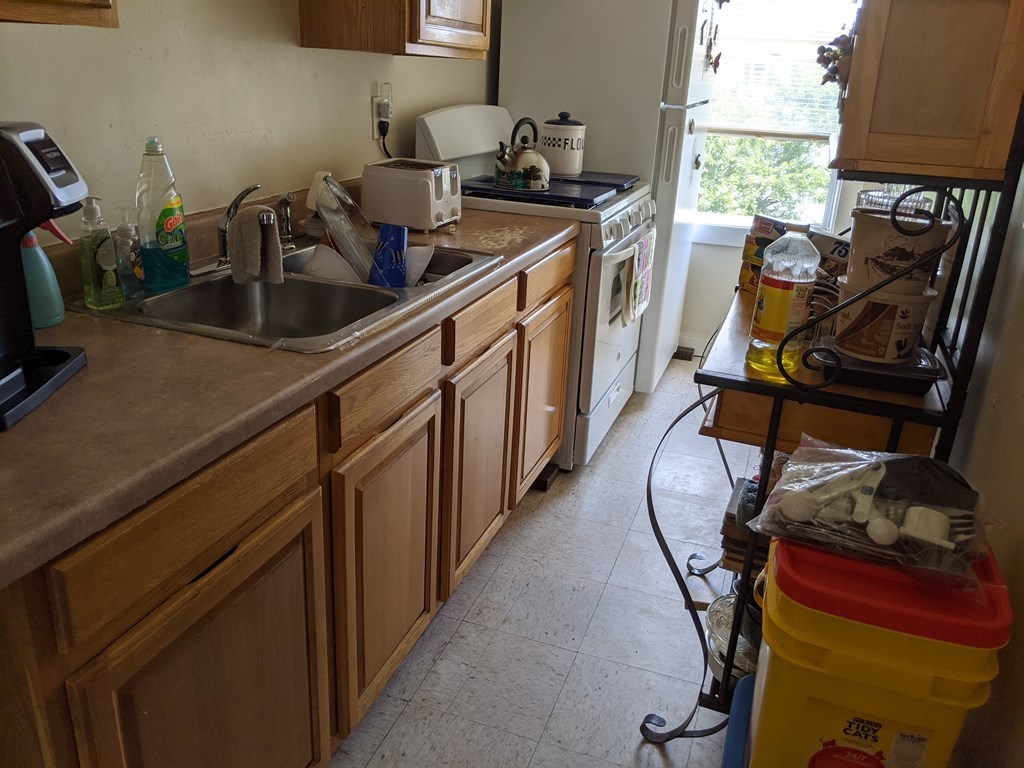 506 4th Street Fall River, MA 02721 - Photo 5 of 8 a kitchen with sink a window and chairs