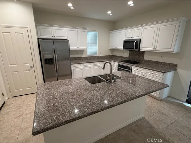 a kitchen with sink stove and cabinets