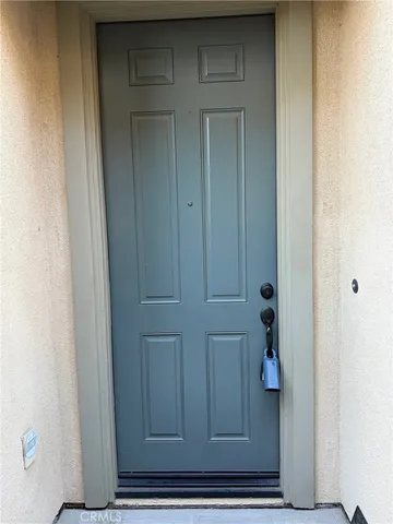 a view of kitchen with sink and refrigerator