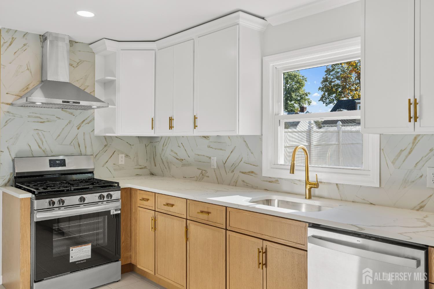 435 Warfield Road North Plainfield, NJ 07063 - Photo 12 of 35 a kitchen with stainless steel appliances white cabinets and a stove top oven