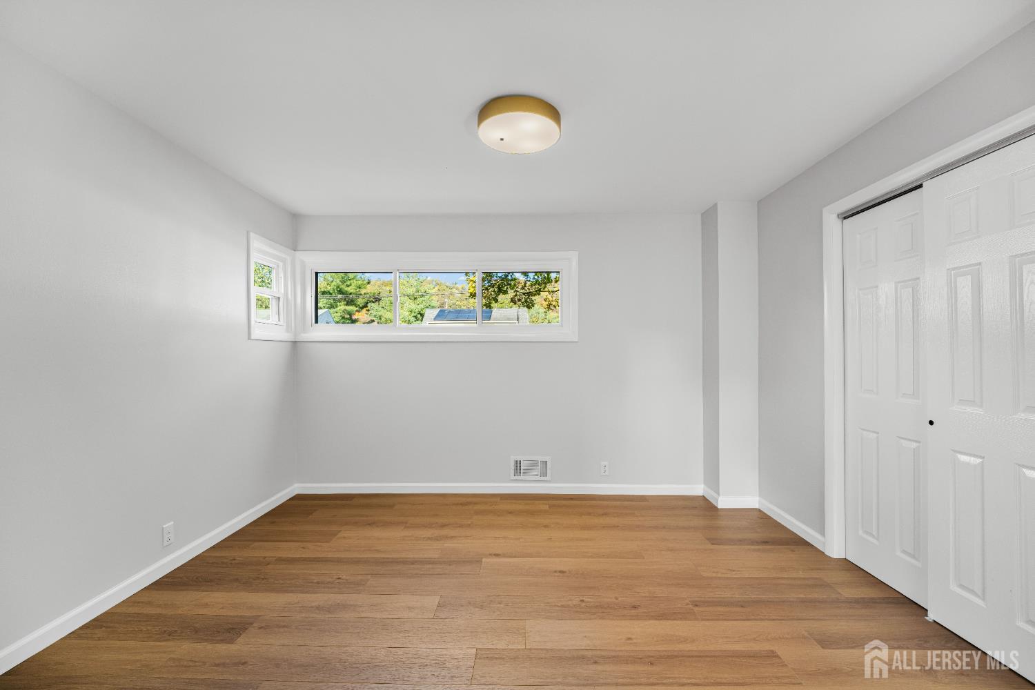 435 Warfield Road North Plainfield, NJ 07063 - Photo 16 of 35 a view of an empty room with wooden floor and a window