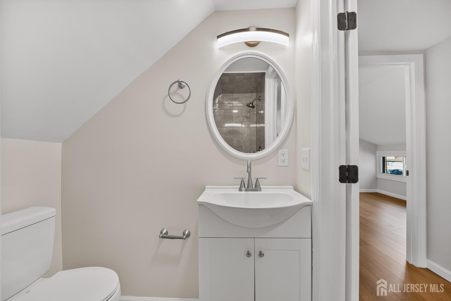 435 Warfield Road North Plainfield, NJ 07063 - Photo 23 of 35 a bathroom with a toilet sink and mirror