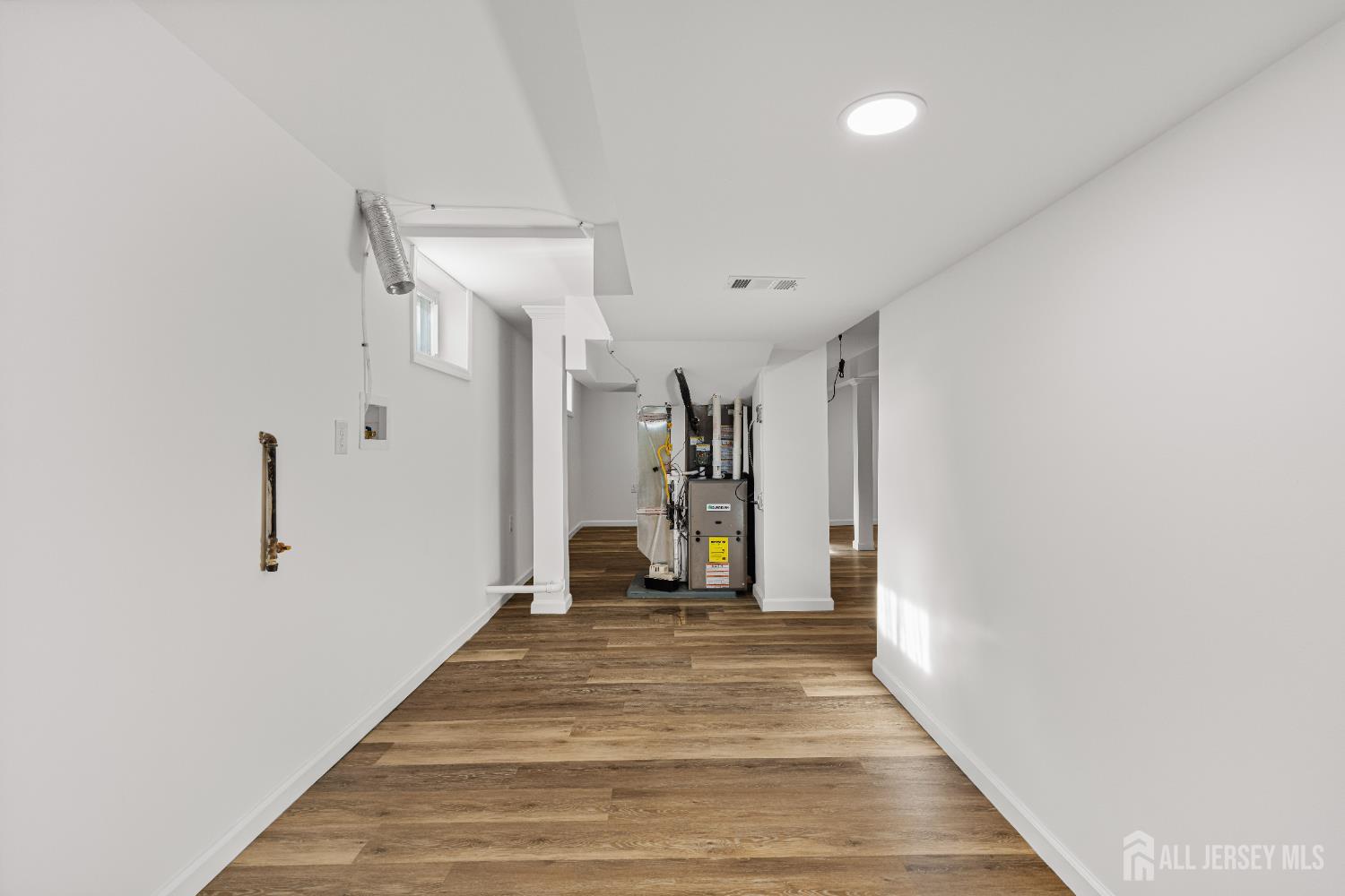 435 Warfield Road North Plainfield, NJ 07063 - Photo 30 of 35 a view of a hallway with wooden floor and a bathroom