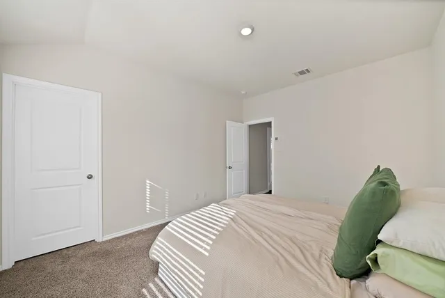 a bedroom with a bed and a rug