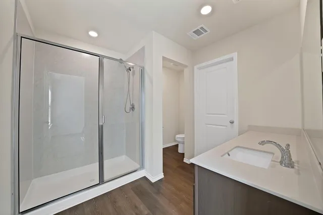 a bathroom with a shower sink and mirror