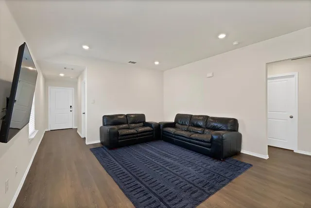a living room with furniture and a rug