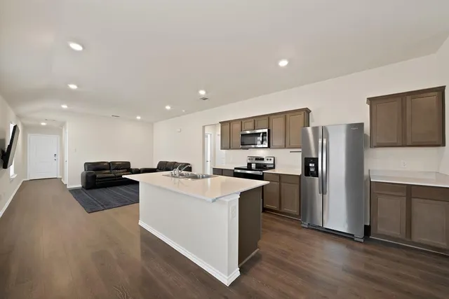a kitchen with refrigerator and microwave