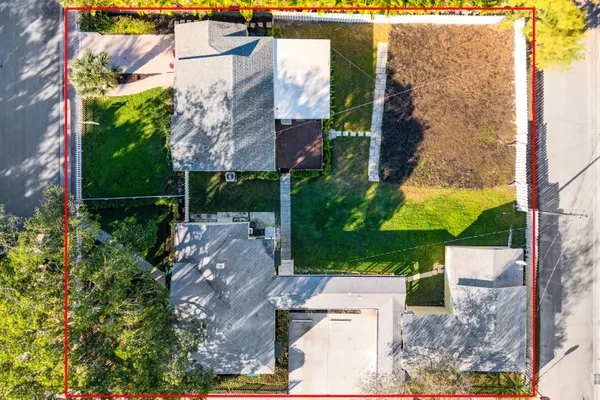 a front view of a house with yard and green space