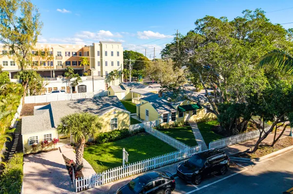 a front view of a multi story residential apartment building with a yard