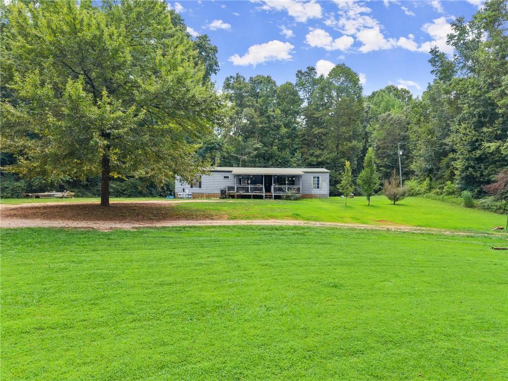 8285 Campground Road Clermont, GA 30527 - Photo 12 of 32 a view of a swimming pool with a yard and large trees