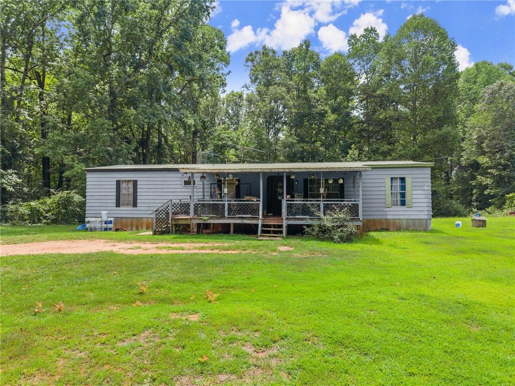8285 Campground Road Clermont, GA 30527 - Photo 16 of 32 a view of a house with a backyard