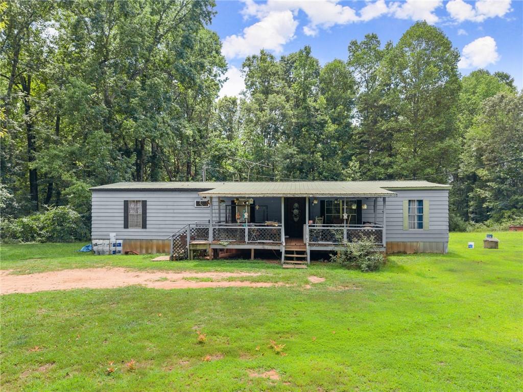 8285 Campground Road Clermont, GA 30527 - Photo 17 of 32 a view of a house with a yard and sitting area