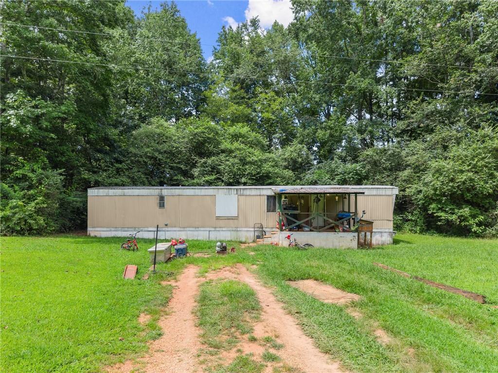 8285 Campground Road Clermont, GA 30527 - Photo 18 of 32 a front view of a house with garden