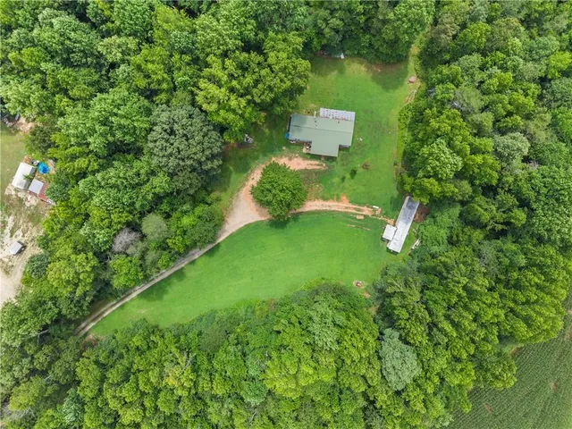 an aerial view of a house with pool yard outdoor seating and yard