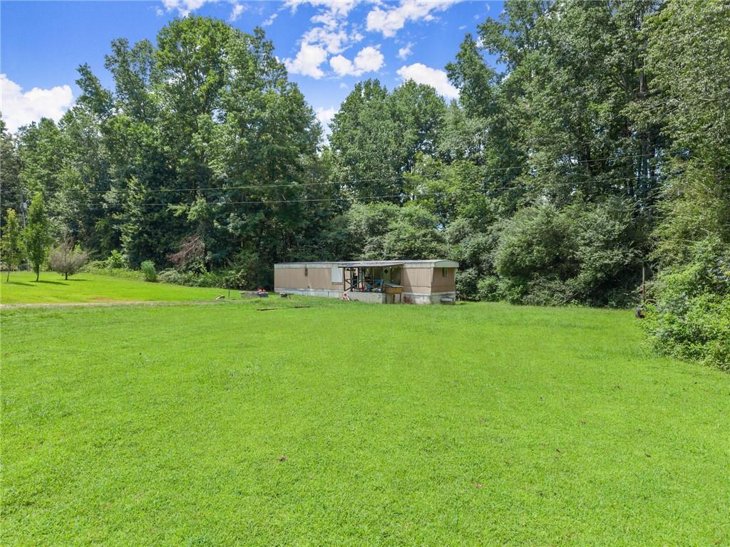 8285 Campground Road Clermont, GA 30527 - Photo 10 of 32 a view of a house with a backyard