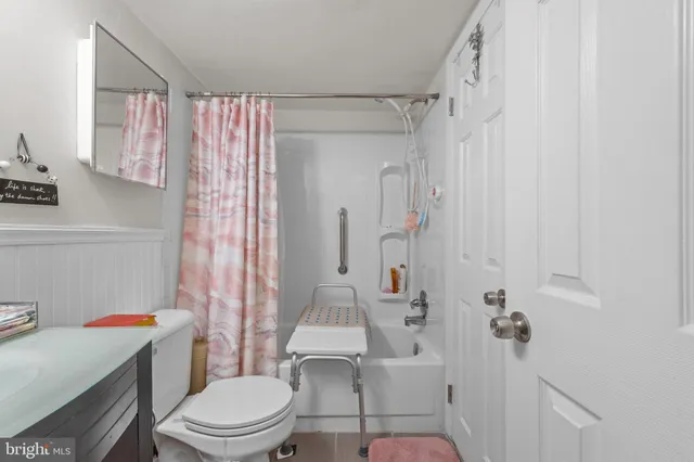 a white toilet sitting next to a bathroom sink