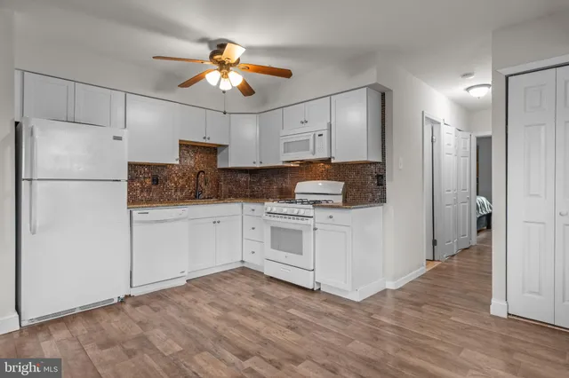 a kitchen with a refrigerator sink and cabinets