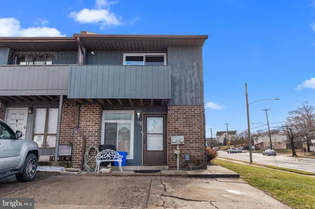 a front view of a house with outdoor seating