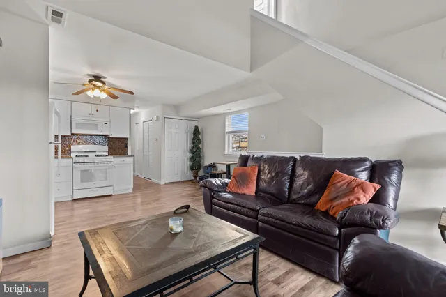 a living room with furniture and kitchen view