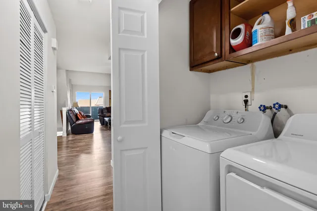 a view of a hallway with workspace and wooden floor