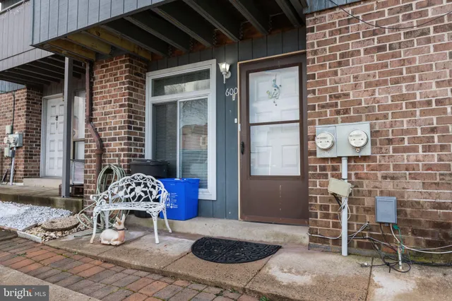 a view of a street with potted plants