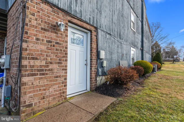 a view of a house with a backyard and a tree