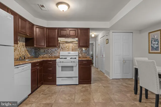 a kitchen with a sink cabinets and stainless steel appliances
